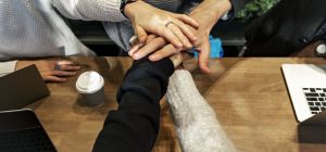 Diverse people stacking hands together